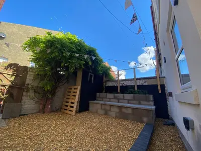 a small courtyard with a ladder next to a building at Blackpool - 4 Beds - Sleeps 10 - Pet Friendly in Blackpool