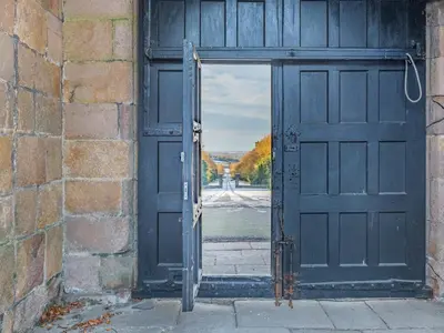 an open door in a brick building with a view at Irishman's Tower in Riley Green