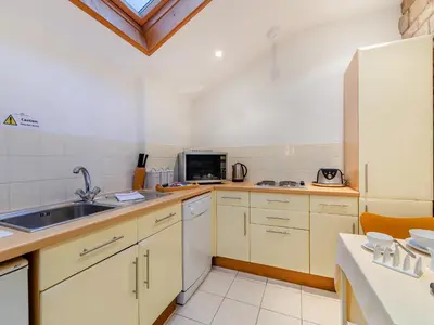 a kitchen with a sink and a refrigerator at Irishman's Tower in Riley Green