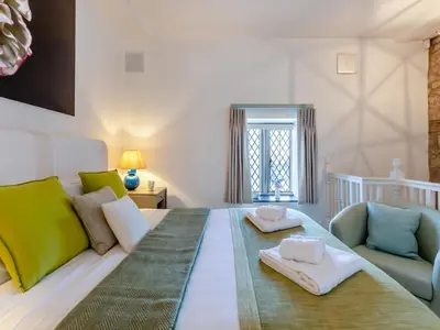 a room with a bed and a couch and a chair at Irishman's Tower in Riley Green