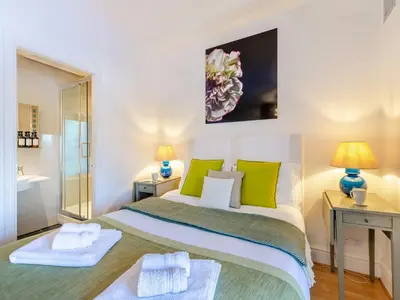 a bedroom with a large bed with green and white pillows at Irishman's Tower in Riley Green