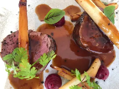 a plate of food with meat and vegetables and sauce at Briardene in Blackpool