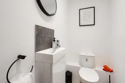 a bathroom with a white toilet and a mirror at Brighton Street Apartment - 2 Bedroom Free Wi-Fi and Parking in Wallasey