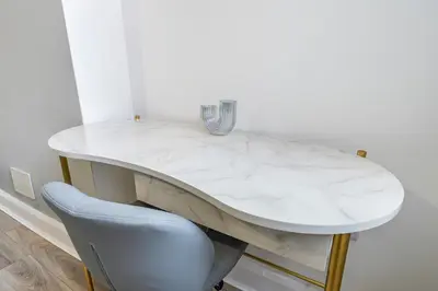 a white marble table with a chair and a vase on it at Contractor Luxury Home - Long Stays - 4 Bedrooms - Sleep 8 - Zip & Link Beds - Ultra Fast WiFi - Free Parking in Birkenhead
