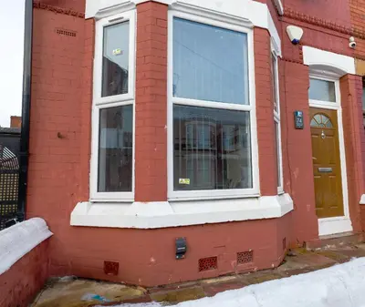 a red brick house with a window and a door at Contractor Luxury Home - Long Stays - 4 Bedrooms - Sleep 8 - Zip & Link Beds - Ultra Fast WiFi - Free Parking in Birkenhead