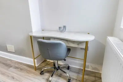 a desk and a chair in a room with a table at Contractor Luxury Home - Long Stays - 4 Bedrooms - Sleep 8 - Zip & Link Beds - Ultra Fast WiFi - Free Parking in Birkenhead