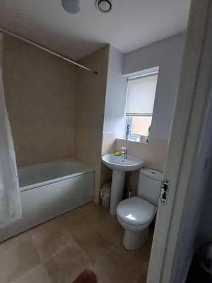 a bathroom with a toilet and a tub and a sink at Great Home in Liverpool