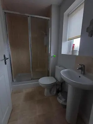 a bathroom with a shower and a toilet and a sink at Great Home in Liverpool