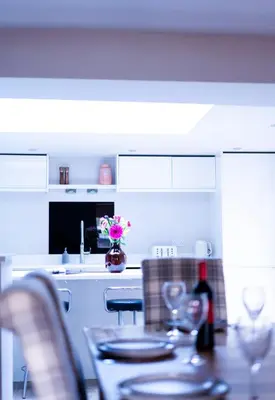 a kitchen with a table with plates and wine glasses at Luxury modern canal side cottage for families, couples, contractors and dog friendly in Lancashire sleeps 6 in Preston