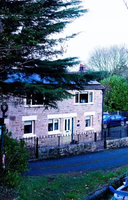 a brick house with a fence next to a street at Luxury modern canal side cottage for families, couples, contractors and dog friendly in Lancashire sleeps 6 in Preston