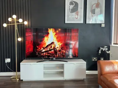 a living room with a fire in a fireplace at Balcony 60 Inch TV Penthouse City Centre with views in Liverpool