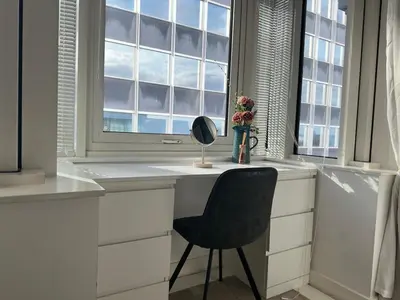 a desk with a chair in front of a window at Balcony 60 Inch TV Penthouse City Centre with views in Liverpool