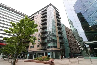 a tall building with a tree in front of it at Balcony 60 Inch TV Penthouse City Centre with views in Liverpool