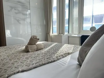 a bedroom with a bed with a towel on it at Balcony 60 Inch TV Penthouse City Centre with views in Liverpool