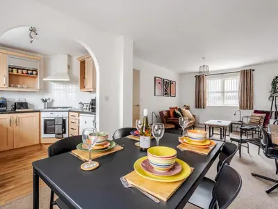 a dining room and kitchen with a table and chairs at The Point, 2 Bed Flat, Parking - Pass the Keys in Liverpool