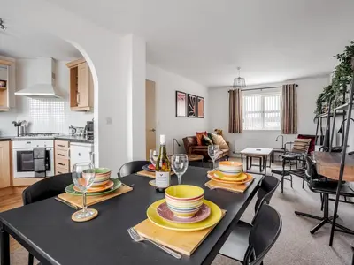 a dining room and kitchen with a table and chairs at The Point, 2 Bed Flat, Parking - Pass the Keys in Liverpool