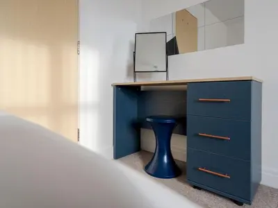 a blue desk with a drawer and a mirror at The Point, 2 Bed Flat, Parking - Pass the Keys in Liverpool
