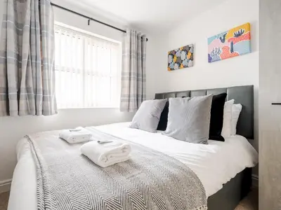 a bedroom with a bed with two towels on it at The Point, 2 Bed Flat, Parking - Pass the Keys in Liverpool