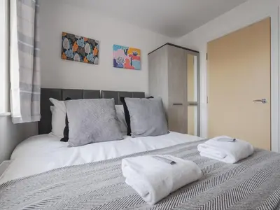 a white bed with two towels on top of it at The Point, 2 Bed Flat, Parking - Pass the Keys in Liverpool