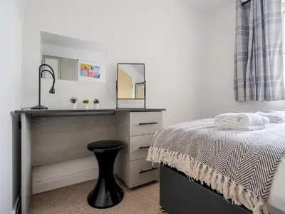 a bedroom with a sink and a bed with a mirror at The Point, 2 Bed Flat, Parking - Pass the Keys in Liverpool