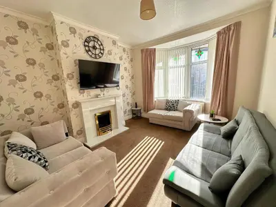 a living room with a couch and a fireplace at Delightful Blackpool Home in Blackpool