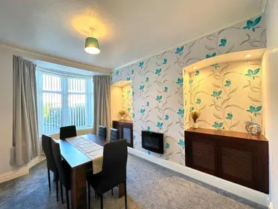 a dining room with a table and some chairs at Delightful Blackpool Home in Blackpool