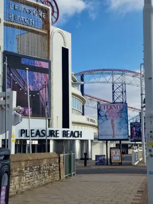 a sign that reads pleasure beach in front of a building at Delightful Blackpool Home in Blackpool