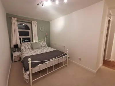 a bedroom with a bed and a window at Cottage Apartment Near Lancaster University in Galgate