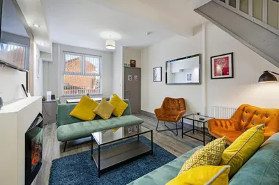 a living room with a couch and chairs at Burnand House - Air Host & Stay - Sleeps 9 in Liverpool