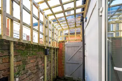 a barn door in a brick wall with a ceiling at Burnand House - Air Host & Stay - Sleeps 9 in Liverpool