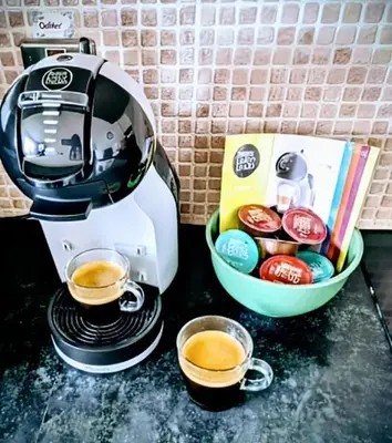 a coffee maker on a counter with two cups of coffee at Cosy Central 2-Bed Flat City View & Parking in Wigan