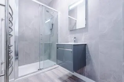 a bathroom with a sink and a shower at Elysée Suites - Stylish 1 Bed Flat in Southport in Southport