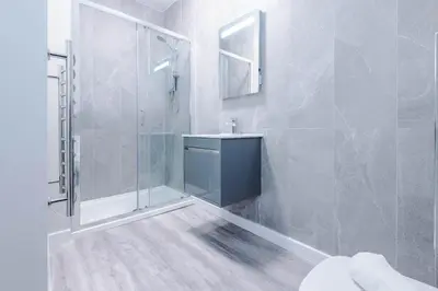 a bathroom with a shower and a sink at Elysée Suites - Stylish 1 Bed Flat in Southport in Southport