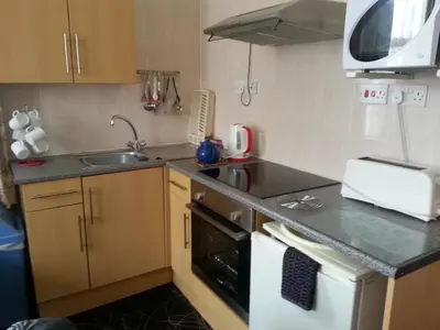 a small kitchen with a sink and a stove at Oakville Apartments in Blackpool