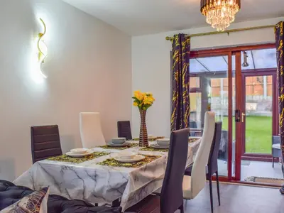 a dining room with a table and chairs at West Park House in Penwortham