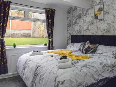 a bedroom with a bed with towels on it at West Park House in Penwortham