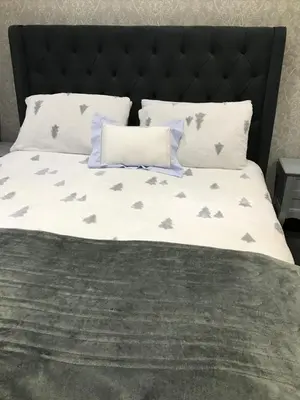 a bed with a black headboard with gray birds on it at Sefton Cottage in Ormskirk