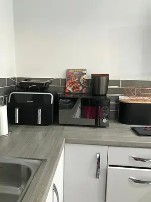 a kitchen with a counter top with a microwave at Sefton Cottage in Ormskirk