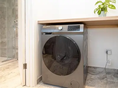 a washer and dryer in a room at Bohemian Apartment, free WiFi and parking in New Brighton