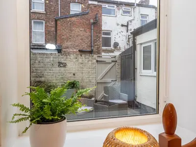 a room with a window with a plant at Bohemian Apartment, free WiFi and parking in New Brighton