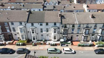 an aerial view of cars parked in front of buildings at Bohemian Apartment, free WiFi and parking in New Brighton
