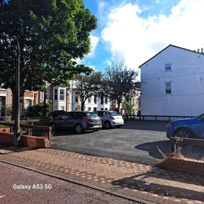 a group of cars parked in a parking lot at Bohemian Apartment, free WiFi and parking in New Brighton