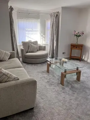 a living room with two couches and a coffee table at 2 Bedroom Beachside House Sleeps 4 - Private Patio in Southport