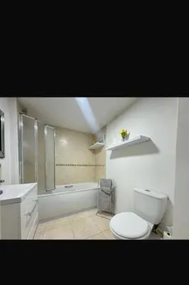 a bathroom with a toilet and a shower and a sink at 2 Bedroom Beachside House Sleeps 4 - Private Patio in Southport