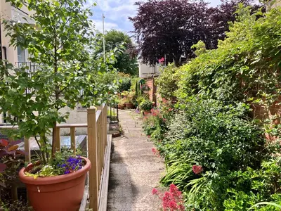 a garden with a fence and a lot of plants at 2 Bedroom Beachside House Sleeps 4 - Private Patio in Southport
