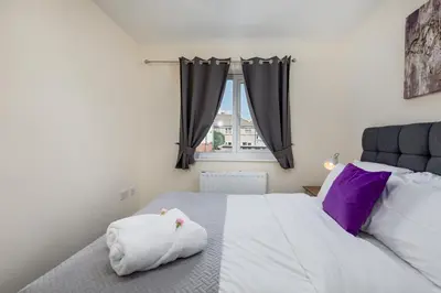 a bedroom with a large white bed with a window at Spacious Luxurious Serviced Accommodation 6 in Barrow in Furness