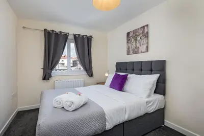 a bedroom with a bed with towels on it at Spacious Luxurious Serviced Accommodation 6 in Barrow in Furness