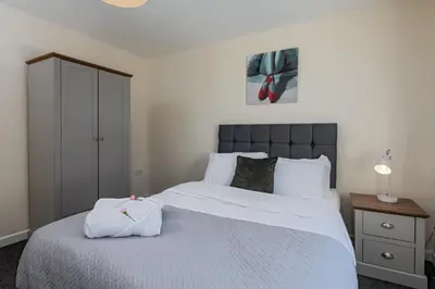 a bedroom with a large bed with white sheets at Spacious Luxurious Serviced Accommodation 6 in Barrow in Furness