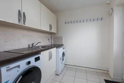 a kitchen with a washing machine and a sink at Spacious Luxurious Serviced Accommodation 6 in Barrow in Furness