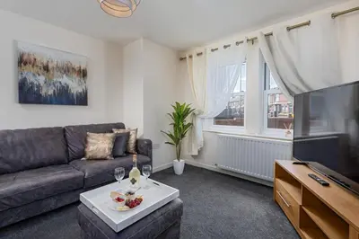 a living room with a couch and a tv at Spacious Luxurious Serviced Accommodation 6 in Barrow in Furness